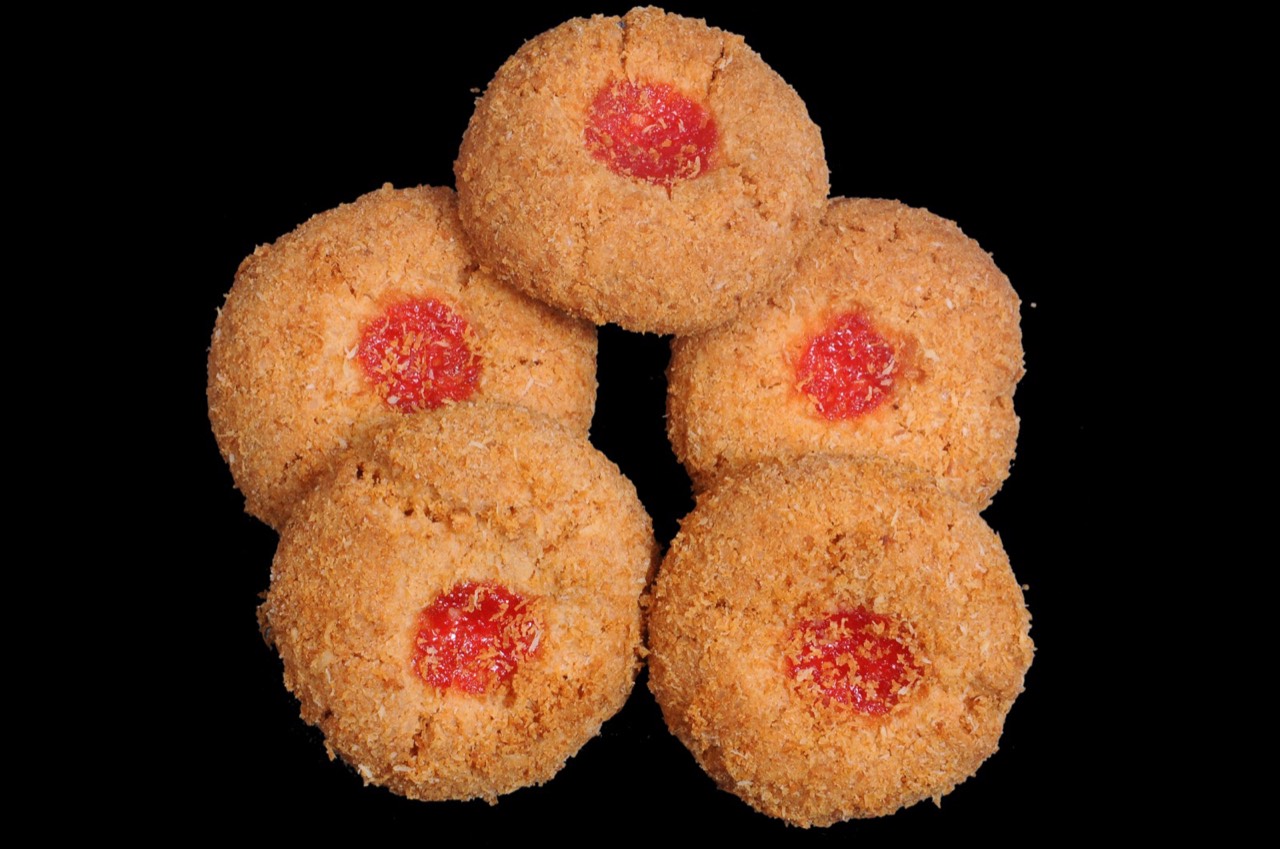 Coconut biscuits with a glacé cherry centre